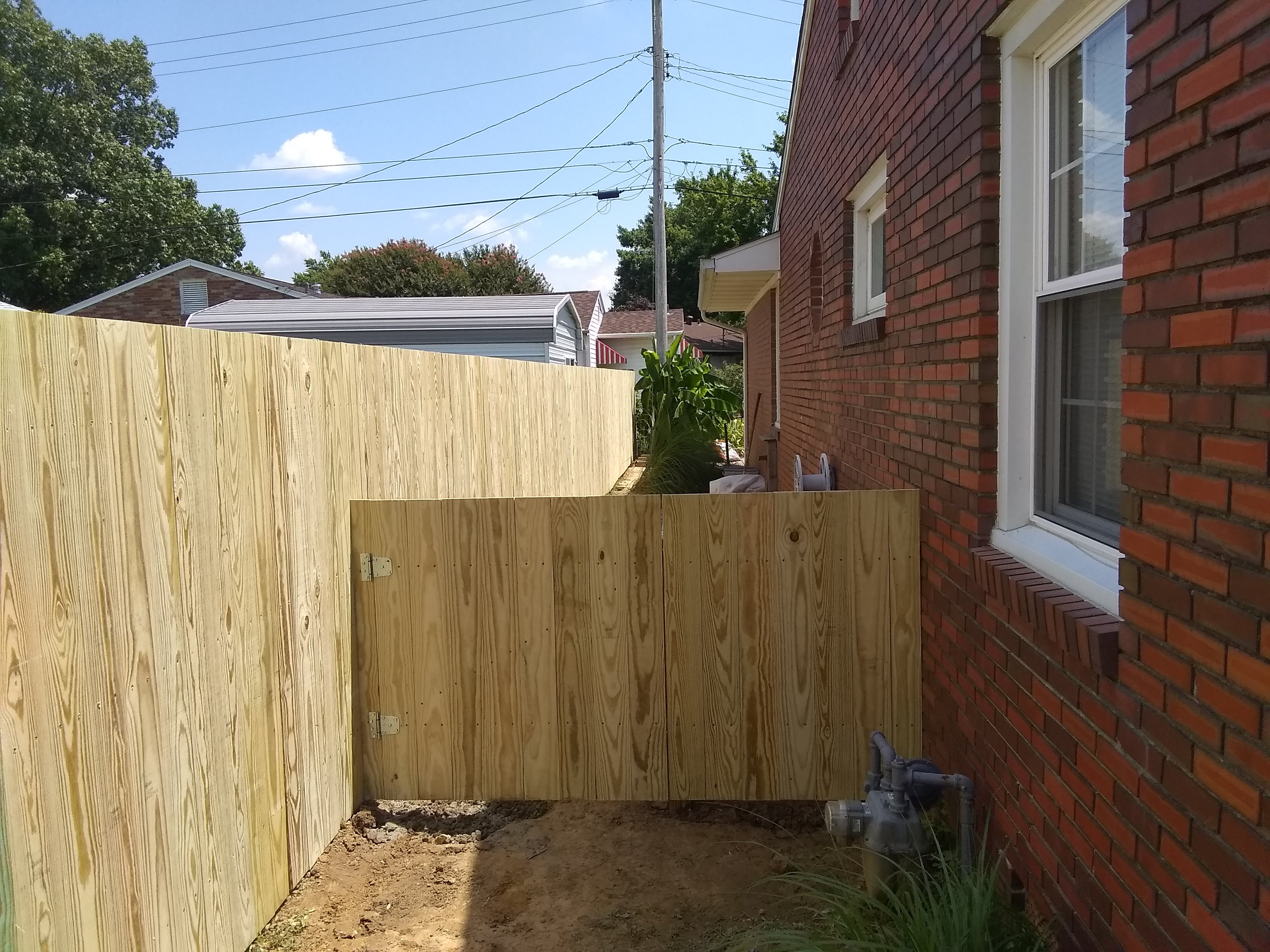 Owensboro Mowing Company crew performing lawn service on a residential property
